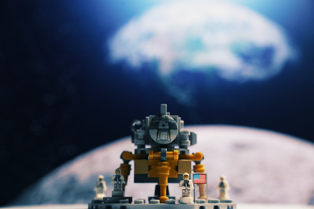 A sophisticated robotic explorer stands on the rocky surface of a desolate exoplanet, silhouetted against a breathtaking backdrop of swirling nebulae and distant galaxies.