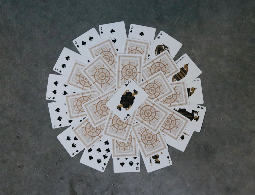 A solitary, oversized domino is caught mid-fall, just making contact with the first in an immense, spiraling chain of countless fallen dominoes that recedes into the distant horizon, illuminated by stark, directional light.