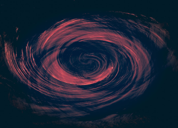 A vibrant red and orange swirling vortex of light against a dark cosmic background powerfully depicts an active black hole or accretion disk.