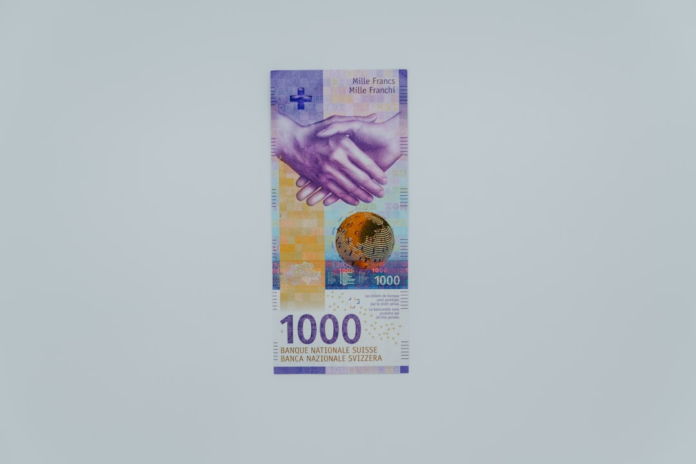 A vibrant 1000 Swiss Franc banknote, featuring a handshake and a global motif, symbolizes digital value and earnings in blockchain-based play-to-earn gaming.