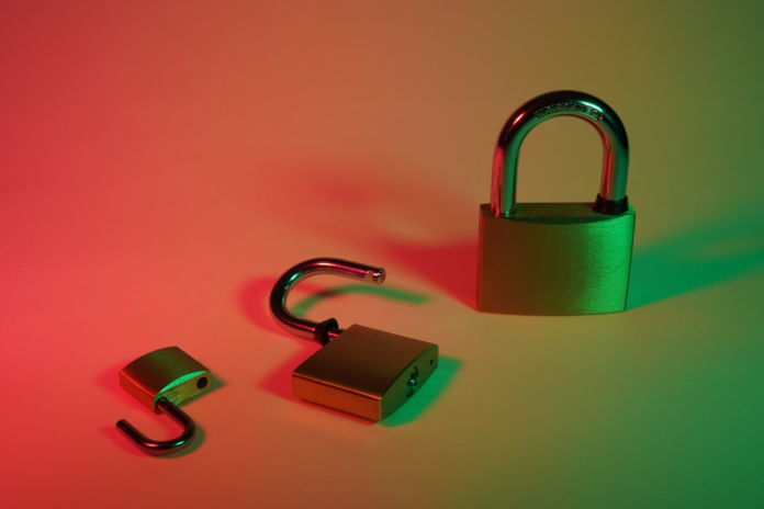 Secure and breached padlocks are illuminated by contrasting red and green light, illustrating the dual nature of data protection in the digital future.