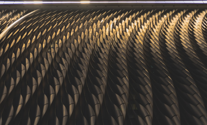 Dark, rippling architectural panels with dramatic interplay of light and shadow create a powerful, consuming visual flow, reminiscent of an immense cosmic force.