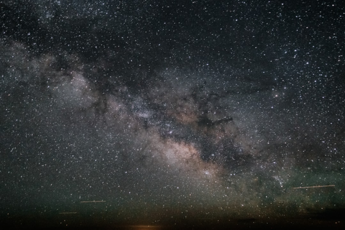 The vast, star-filled band of the Milky Way galaxy stretches across a dark night sky, illustrating the cosmic scale Gaia aims to map with precision.