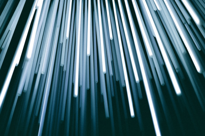 Abstract glowing blue and white lines emerging from a dark background evoke streams of data or profound insights, symbolizing the exploration of reality's mysteries in metaphysics and epistemology.