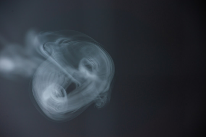 Swirling white vapor against a dark void symbolizes the enigmatic dynamics of near-horizon phenomena around a quasi-black hole.