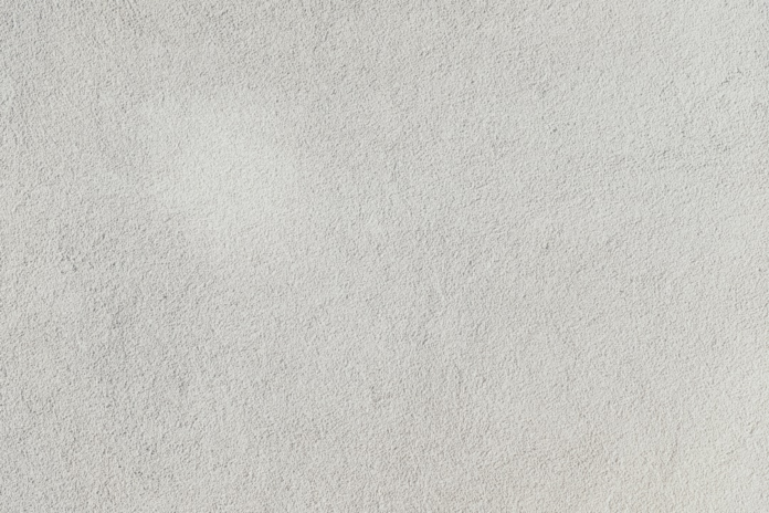 Light gray travertine stone surface displaying its characteristic rough, porous texture.