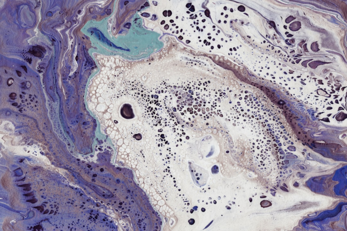 Abstract fluid art with swirling patterns of purple, white, and teal hues, featuring intricate clusters of dark and light cell-like bubbles that evoke the microscopic processes of yeast respiration.